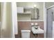 Functional bathroom with white tiling, a standard sink, toilet, and a shower featuring neutral and clean accents at 403 E Mcpherson Dr, Mebane, NC 27302