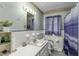 Well-lit bathroom featuring a classic sink, toilet, and shower with stylish blue accents and ample amenities at 403 E Mcpherson Dr, Mebane, NC 27302