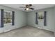 Inviting bedroom with neutral paint, carpet floors, and two bright windows at 403 E Mcpherson Dr, Mebane, NC 27302