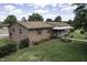 Brick home on a lush green lawn, complete with a covered front porch at 403 E Mcpherson Dr, Mebane, NC 27302