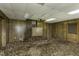 Spacious carpeted room featuring wood paneling, a fan, and staircase; an inviting space awaiting your personal touch at 403 E Mcpherson Dr, Mebane, NC 27302