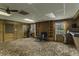 Cozy living room with wood paneling, brick fireplace, and carpeted floor, creating a warm and inviting atmosphere at 403 E Mcpherson Dr, Mebane, NC 27302