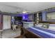 Spacious main bedroom featuring a TV, unique bar, large window and king bed with inviting blue tones at 403 E Mcpherson Dr, Mebane, NC 27302