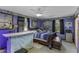 Spacious main bedroom featuring a bar, large window, king bed with inviting blue tones, and dark wood accents at 403 E Mcpherson Dr, Mebane, NC 27302