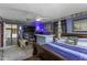 Spacious main bedroom featuring a TV, unique bar, large window and king bed with inviting blue tones at 403 E Mcpherson Dr, Mebane, NC 27302