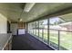Bright sunroom with screened windows, offering a view of the lush green yard; perfect for relaxation at 403 E Mcpherson Dr, Mebane, NC 27302