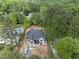 Aerial view of a new home construction surrounded by lush greenery and neighboring houses at 5013 Coronado, Raleigh, NC 27609