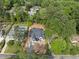 Aerial view of a new home construction surrounded by lush greenery and neighboring houses, showing the pool at 5013 Coronado, Raleigh, NC 27609