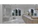 Luxurious bathroom with a modern shower, marble tile, and large window with natural light and stylish fixtures at 5013 Coronado, Raleigh, NC 27609
