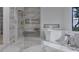 Modern bathroom featuring a glass-enclosed shower, freestanding tub, and stylish fixtures and recessed shelves at 5013 Coronado, Raleigh, NC 27609