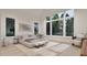 Bright bedroom featuring a modern bed, neutral decor, and large windows with a view of the trees at 5013 Coronado, Raleigh, NC 27609