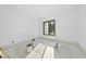 Bright bedroom featuring fresh white walls, a large window, and a clean, minimalist aesthetic at 5013 Coronado, Raleigh, NC 27609