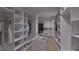 Spacious walk-in closet with custom shelving, ample storage space, and a washer and dryer at 5013 Coronado, Raleigh, NC 27609