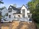 Beautiful new construction exterior with gray roof, black frame windows, white brick and covered entry at 5013 Coronado, Raleigh, NC 27609