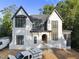 New construction exterior featuring white brick, black trim windows, covered entry and professional design at 5013 Coronado, Raleigh, NC 27609