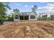 Charming two-story home featuring a rear patio and dark window frames, set in a landscaped yard at 5013 Coronado, Raleigh, NC 27609