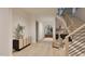 Elegant foyer with light hardwood floors, stairs and a view of the arched entryway at 5013 Coronado, Raleigh, NC 27609