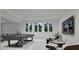 Spacious game room with a pool table, modern seating, and an entertainment area with natural light at 5013 Coronado, Raleigh, NC 27609