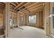 Interior of a home under construction, with exposed wood framing and large window opening to a view at 5013 Coronado, Raleigh, NC 27609