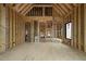 Interior view of new construction home with exposed framing, showing the layout and window placements at 5013 Coronado, Raleigh, NC 27609