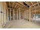Framing of open concept interior with exposed duct work, bench, and large window at 5013 Coronado, Raleigh, NC 27609