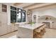 Open kitchen with a large marble island, professional range, and ample natural light at 5013 Coronado, Raleigh, NC 27609