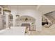 Well-appointed kitchen featuring stainless steel appliances, marble counters, and a view of the staircase at 5013 Coronado, Raleigh, NC 27609