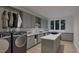 Well-organized laundry room with modern appliances, gray cabinetry, and ample counter space at 5013 Coronado, Raleigh, NC 27609
