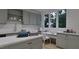 Efficient laundry area with gray cabinets, a workstation, and a view of the outdoors at 5013 Coronado, Raleigh, NC 27609
