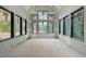Bright room with multiple large windows providing ample natural light, walls are in process of drywall at 5013 Coronado, Raleigh, NC 27609