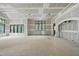 Spacious living room with large windows offering natural light and views, walls are in process of drywall at 5013 Coronado, Raleigh, NC 27609