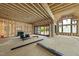 Unfinished living room featuring exposed wood beams and large windows for ample natural light at 5013 Coronado, Raleigh, NC 27609
