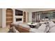 Spacious living room with a fireplace, built-in bookshelves, modern lighting, and view of kitchen at 5013 Coronado, Raleigh, NC 27609