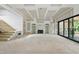 Living room featuring staircase and fireplace, with access to outdoor area, walls are in process of drywall at 5013 Coronado, Raleigh, NC 27609
