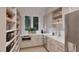 Walk-in pantry boasts ample storage with bright cabinetry, countertop, and natural light at 5013 Coronado, Raleigh, NC 27609