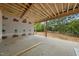 A covered patio area with exposed wooden beams, offering a tranquil outdoor space at a new construction home at 5013 Coronado, Raleigh, NC 27609