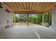 A covered patio area with exposed wooden beams, offering a tranquil outdoor space at a new construction home at 5013 Coronado, Raleigh, NC 27609