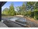 In-ground pool under construction with separate spa and tanning ledge surrounded by lush landscaping at 5013 Coronado, Raleigh, NC 27609