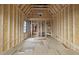 Spacious unfinished room with exposed wood framework, a window, and endless potential for customization at 5013 Coronado, Raleigh, NC 27609