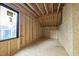 Unfinished room featuring wood framework, a window, and space for personalized design and development at 5013 Coronado, Raleigh, NC 27609