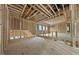 Open-concept unfinished room with wood framework, bright windows, and flexible space for personalization at 5013 Coronado, Raleigh, NC 27609