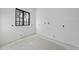 Well-lit room showcasing a large window and white walls with freshly installed piping at 5013 Coronado, Raleigh, NC 27609