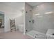 Bathroom showcasing a shower, a tub, neutral tiling, and a decorative ladder at 5060 Trotter Dr, Raleigh, NC 27603