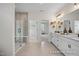 Bright bathroom featuring a double vanity, a shower, and neutral tiling at 5060 Trotter Dr, Raleigh, NC 27603