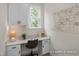 Bright and functional home office with built-in cabinets, a sleek desk, and a convenient wall calendar at 5060 Trotter Dr, Raleigh, NC 27603