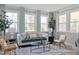 Bright sun room with large windows, comfortable seating, and elegant curtains at 5060 Trotter Dr, Raleigh, NC 27603