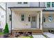 Charming front porch with wood decking, gray front door, and well-maintained landscaping at 5061 Lundy Dr # 101, Raleigh, NC 27606