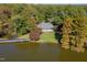 Picturesque waterfront home with a private pier, lush lawn, and stunning lake views from above at 5405 Bluet Ct, Holly Springs, NC 27540