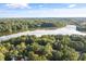 Breathtaking aerial view of a lake surrounded by lush green trees, offering a tranquil escape at 5405 Bluet Ct, Holly Springs, NC 27540
