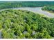 Stunning aerial view of homes nestled in lush greenery with the lake just a short distance away at 5405 Bluet Ct, Holly Springs, NC 27540